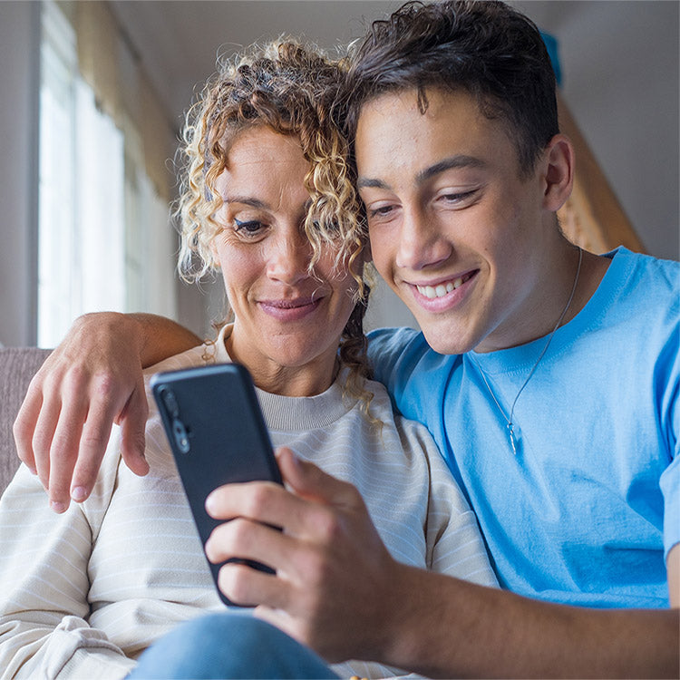 mom and son on phone looking at soccer trials in europe