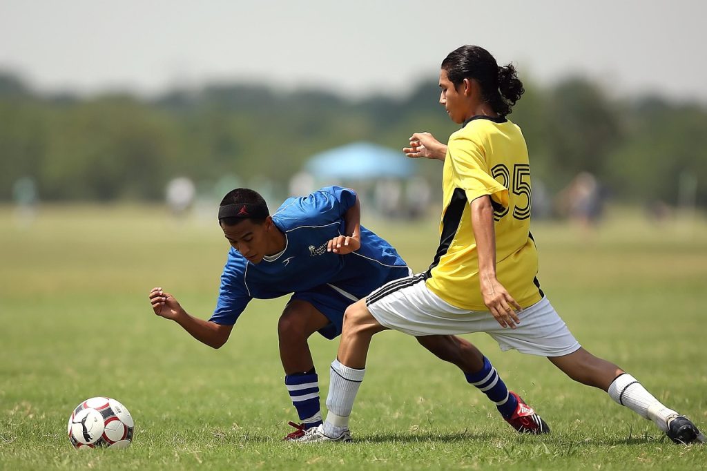 Two young men playing football